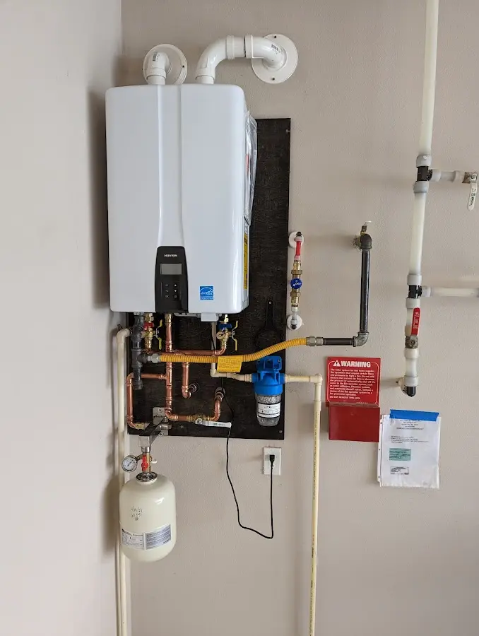 Professional plumber installing copper piping in a Norton Shores home